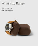 The TAWBURY Bayswater Watch Box Pillow in Brown/Grey, X-Small (50mm), elegantly displays a wristwatch with a brown strap, offering snug support for wrist sizes 5.5-6.5 inches (14-16.5 cm) and perfectly complements Bayswater Watch Boxes for enhanced style and protection.