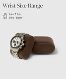 A silver watch with a black-and-white face rests elegantly on a Bayswater Watch Box Pillow - Brown/Grey by TAWBURY, fitting wrists sized 6.6-7.1 inches (16.6-18 cm), perfect for customisable luxury watch storage.