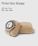 A silver watch with a black bezel and chronograph dials rests elegantly on a Bayswater Watch Box Pillow by TAWBURY, suited for wrist sizes 16.6 - 18 cm (6.6 - 7.1 inches).