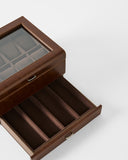 The TAWBURY Bayswater 8 Slot Watch Box with Storage in brown faux leather has a glass lid, upper watch slots, and a lower pull-out drawer for extra storage.