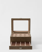 The TAWBURY Bayswater 8 Slot Watch Box with Storage in taupe features a glass lid, eight watch pillows for organized storage, and an open lower drawer with multiple accessory compartments.