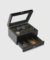 TAWBURY's Bayswater 8 Slot Watch Box in Black/Charcoal is ideal for enthusiasts, displaying three stunning timepieces on top and featuring a drawer below with extra stylish and sustainable vegan leather bands.