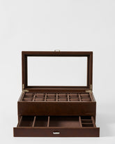 The TAWBURY Bayswater 12 Slot Watch Box with Storage in brown features an open glass lid, multiple compartments, and a lower drawer for extra watch and accessory storage.