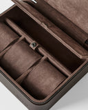 The TAWBURY Fraser 3 Watch Case with Storage in brown features a suede-lined interior, multiple compartments, and a snap-button closure, shown here in close-up.