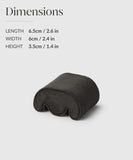 The Fraser Watch Case Pillow in Charcoal by TAWBURY is a wave-shaped cushion, ideal for slender wrists. It measures 6.5 cm in length, 6 cm in width, and 3.5 cm in height—perfect for those who admire the elegance of Fraser Black leather watch travel cases.