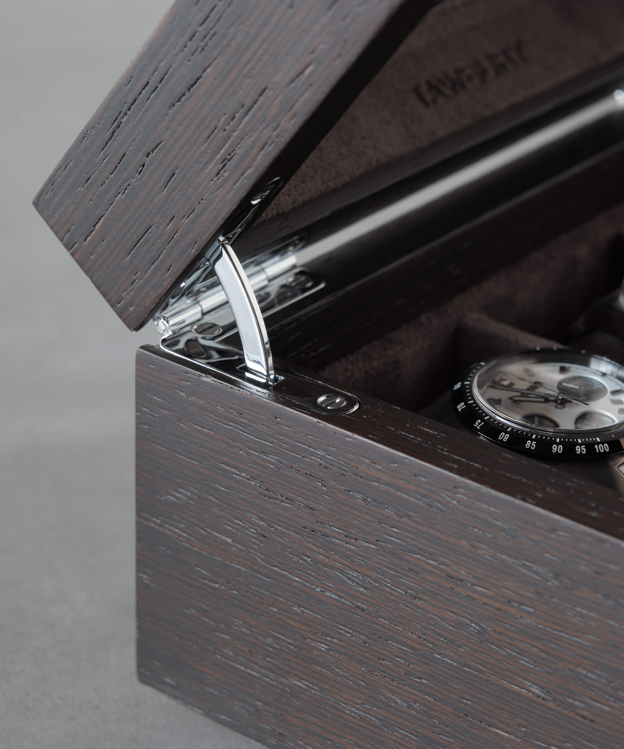 A timepiece displayed in a Grove 6 Slot Watch Box with Glass Lid - Kassod by TAWBURY.