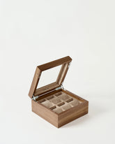 The TAWBURY Grove 6 Slot Wooden Watch Box in Light Walnut features a glass lid and six beige felt-lined compartments—an elegant display case for your prized watches.