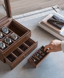 A person is holding a TAWBURY Bayswater 6 Watch Jewellery Box - Brown in a brown vegan leather box.