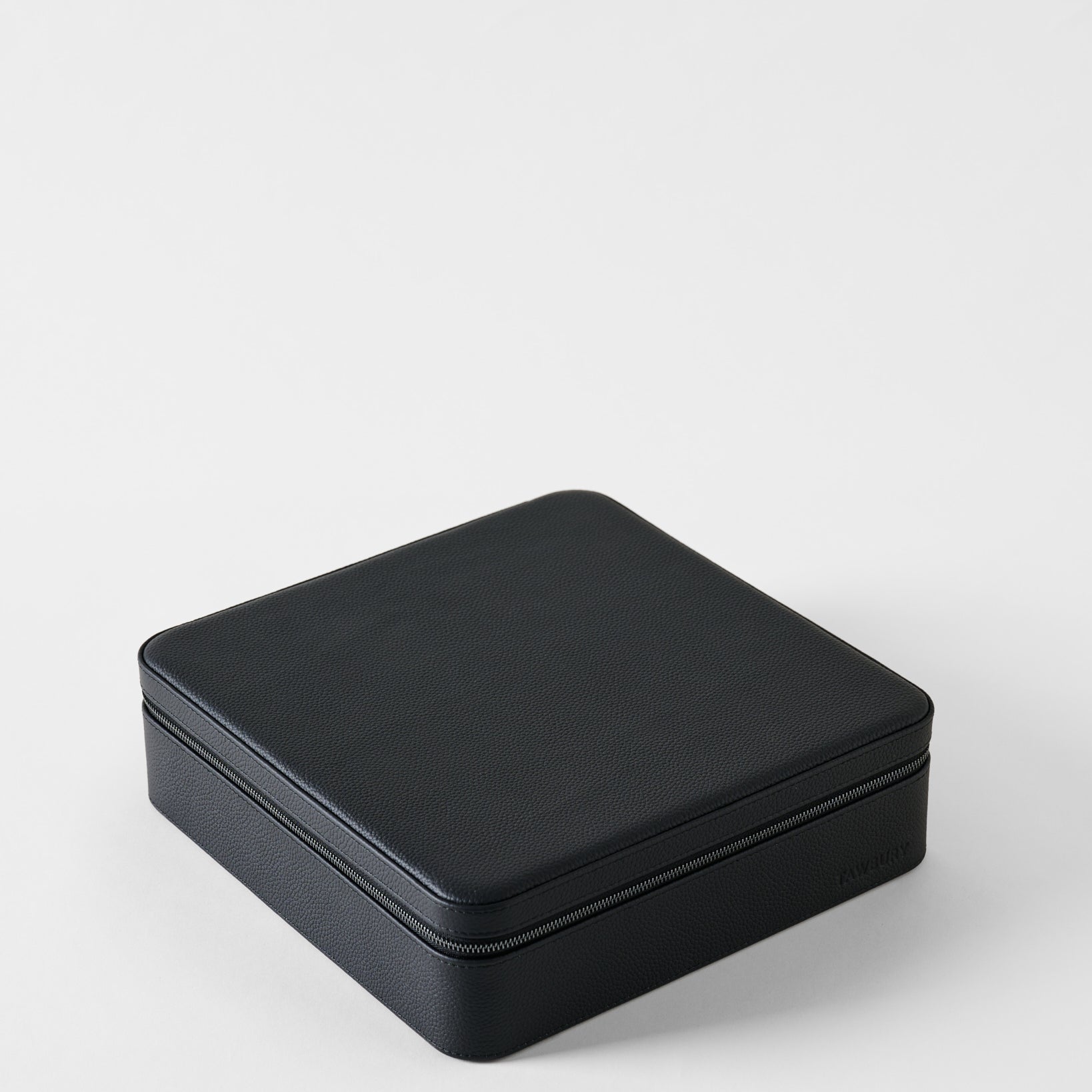 Closed rectangular black leather TAWBURY Fraser 12 Watch Case - Midnight Black with a zippered edge for watch storage.