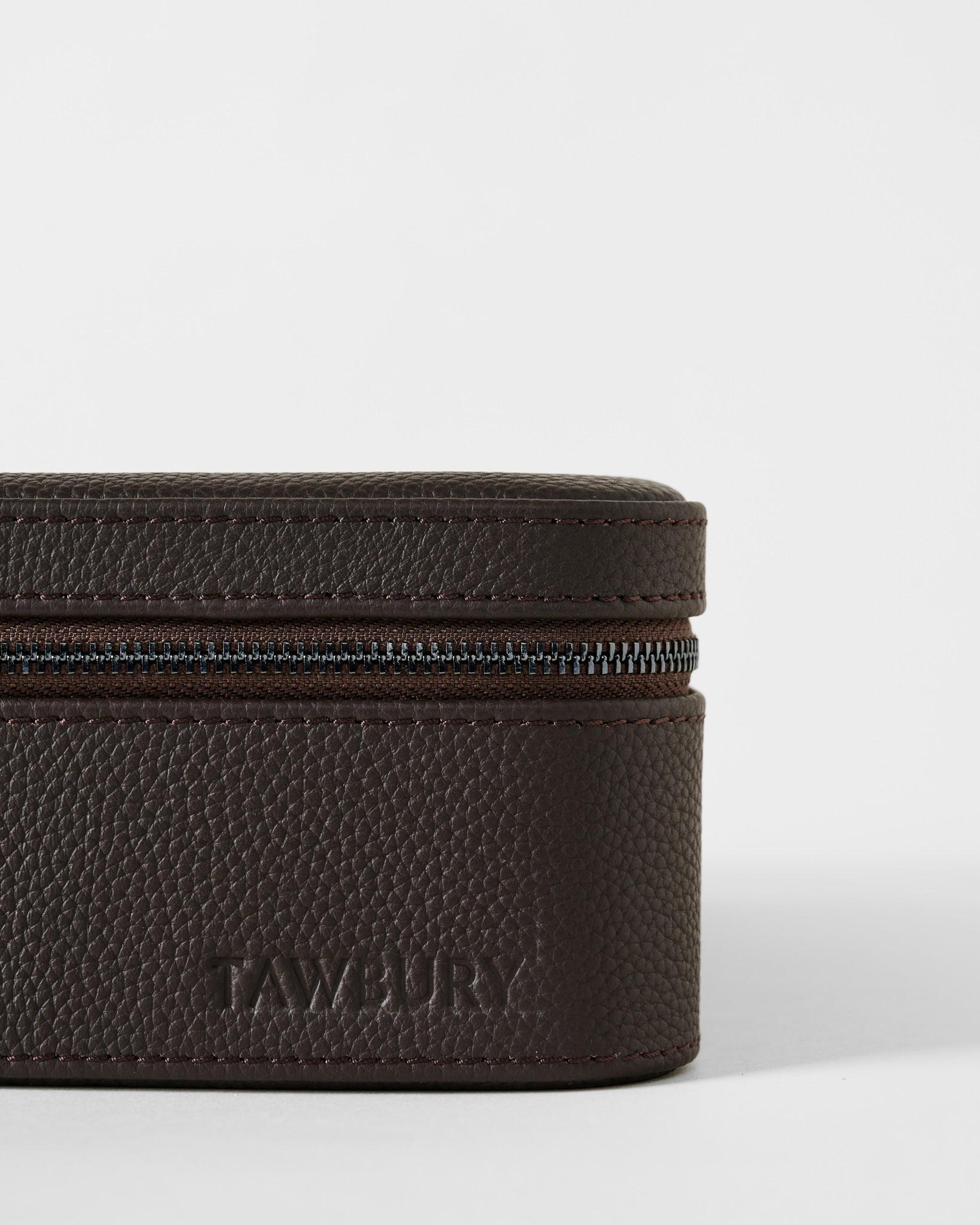 Close-up of a Fraser 3 Watch Case with Storage - Espresso Brown, a brown, leather-textured travel watch box with a zippered closure.