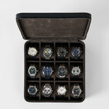 Open midnight black TAWBURY Fraser 12 Watch Case with twelve individual compartments, each containing a different analog wristwatch.