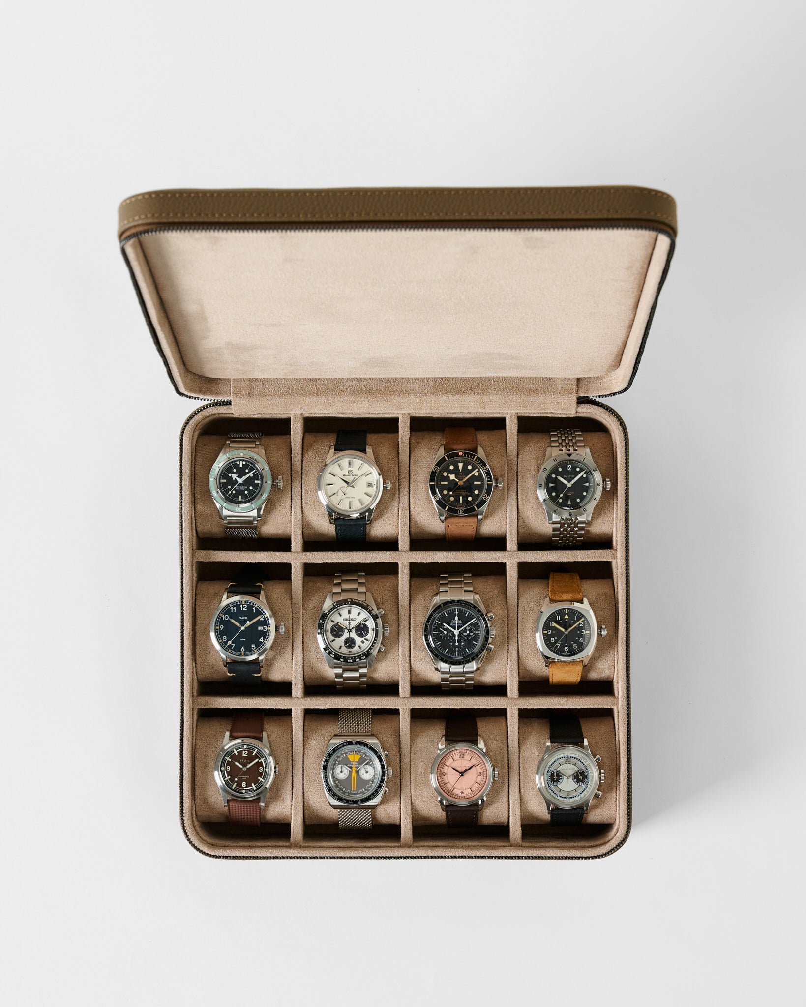 Open TAWBURY Fraser 12 Watch Case - Truffle Taupe leather box with twelve slots, each containing a different analog wristwatch.