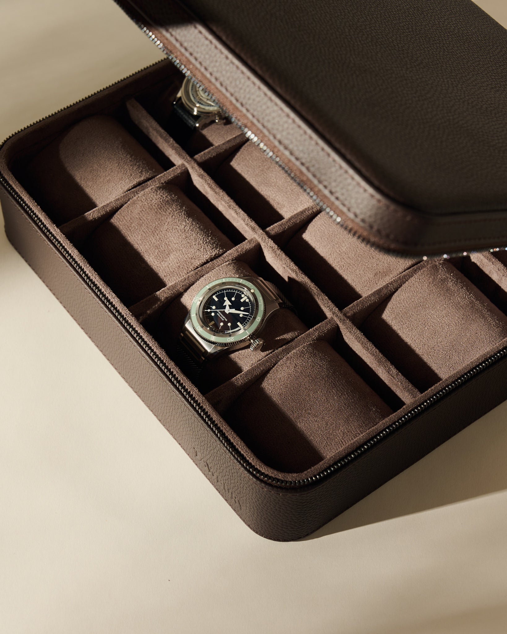 Espresso brown TAWBURY Fraser 12 Watch Case with twelve compartments, each featuring a soft cushion, containing two wristwatches.