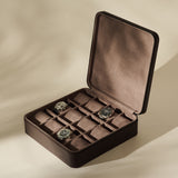 Open TAWBURY Fraser 12 Watch Case - Espresso Brown with twelve storage slots, three of which contain wristwatches.