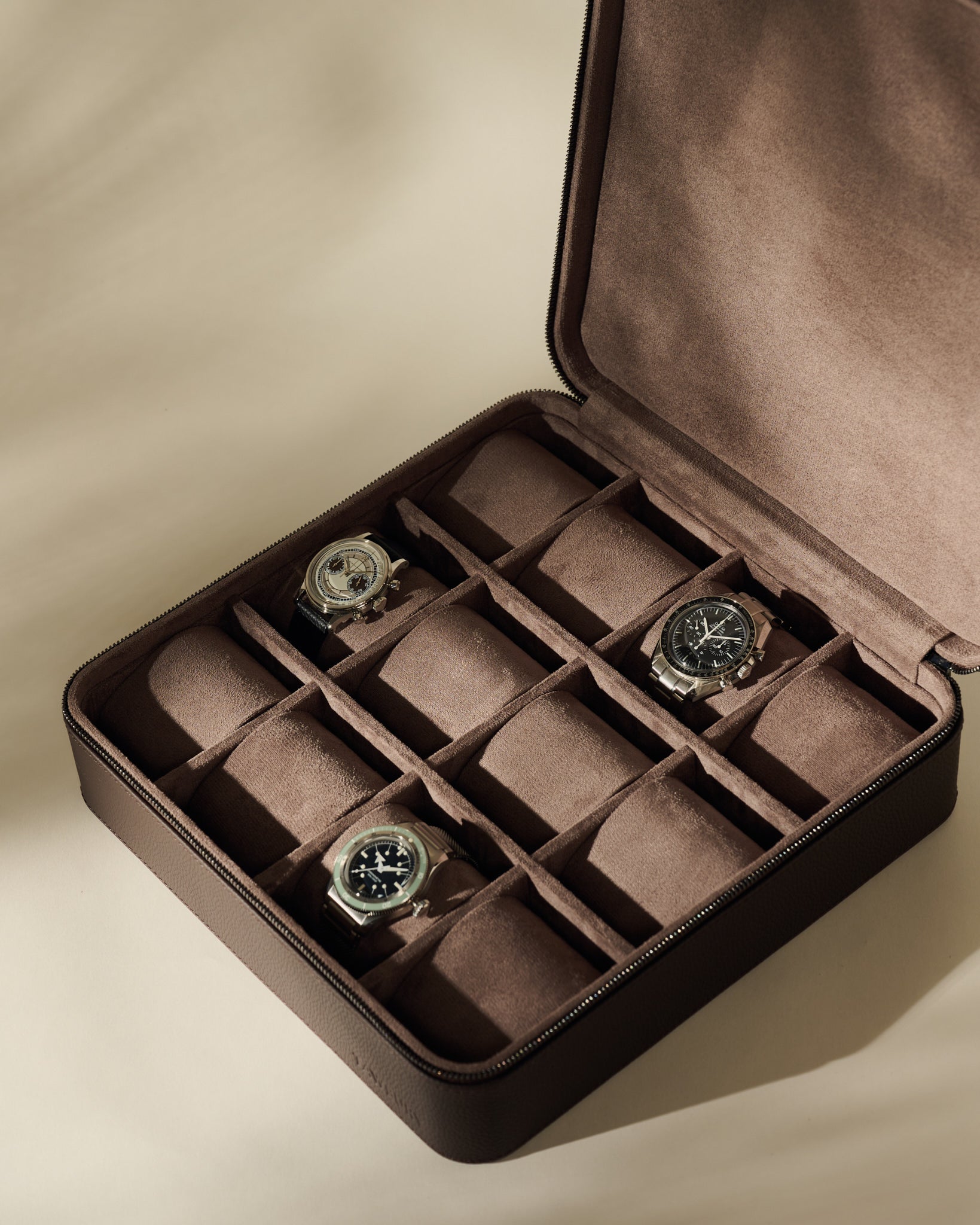Open TAWBURY Fraser 12 Watch Case - Espresso Brown with twelve compartments, three of which hold wristwatches.