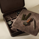 An espresso brown TAWBURY Fraser 12 Watch Case holding two watches, with an additional watch, two spare straps, and a spring bar tool on the interior tray.