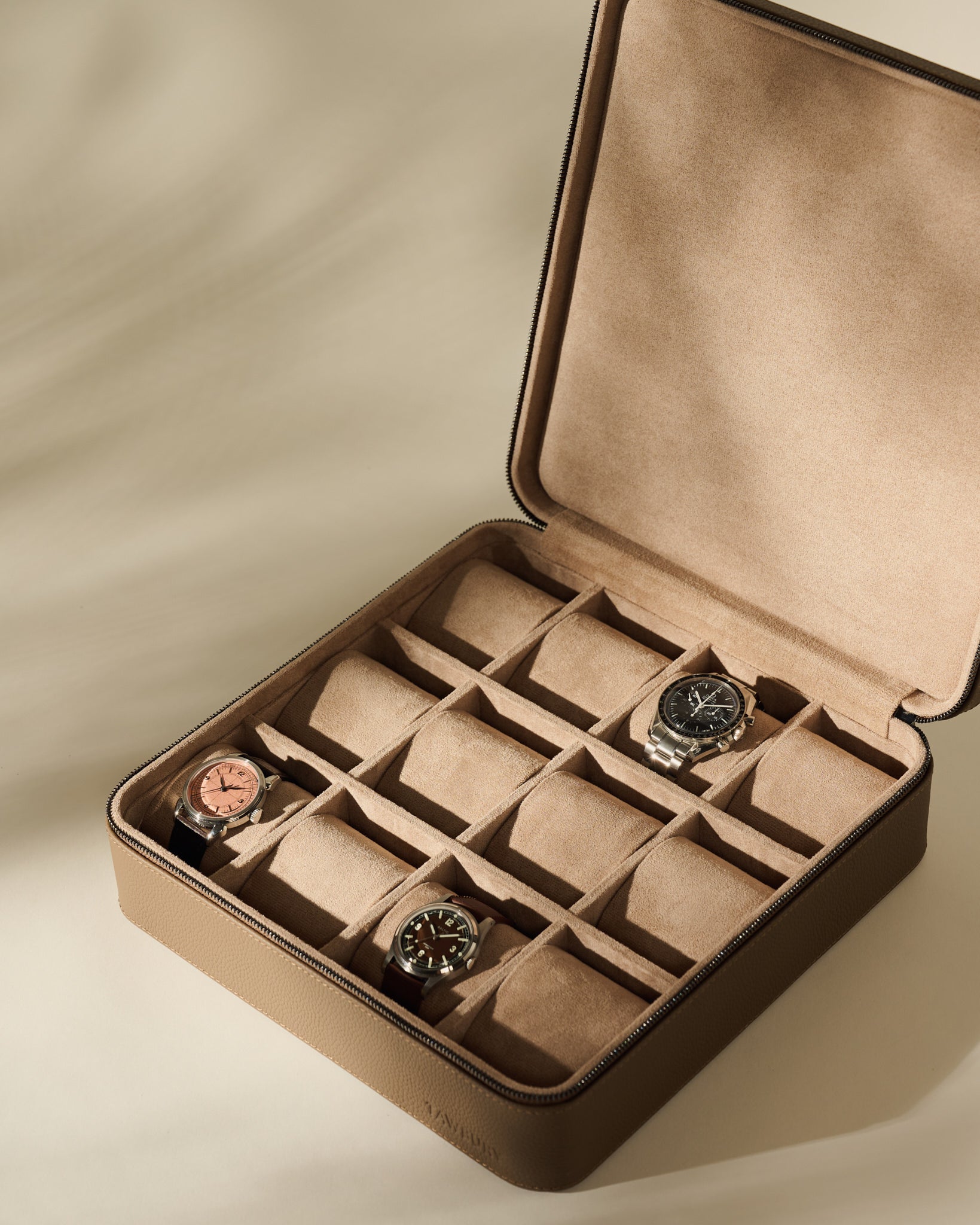 Open Fraser 12 Watch Case - Truffle Taupe with twelve slots, containing three wristwatches.