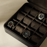 A TAWBURY Fraser 12 Watch Case - Midnight Black, a twelve-slot zippered leather watch box containing three wristwatches.