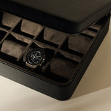 An open TAWBURY Fraser 12 Watch Case - Midnight Black containing a single chronograph wristwatch in a twelve-compartment tray.