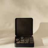 Open black TAWBURY Fraser 12 Watch Case - Midnight Black with twelve interior compartments, containing three wristwatches.