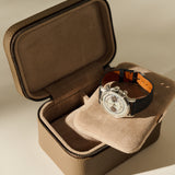 Open TAWBURY Fraser 2 Watch Case - Truffle Taupe with a cream-colored interior, displaying a silver chronograph wristwatch with a black leather strap.