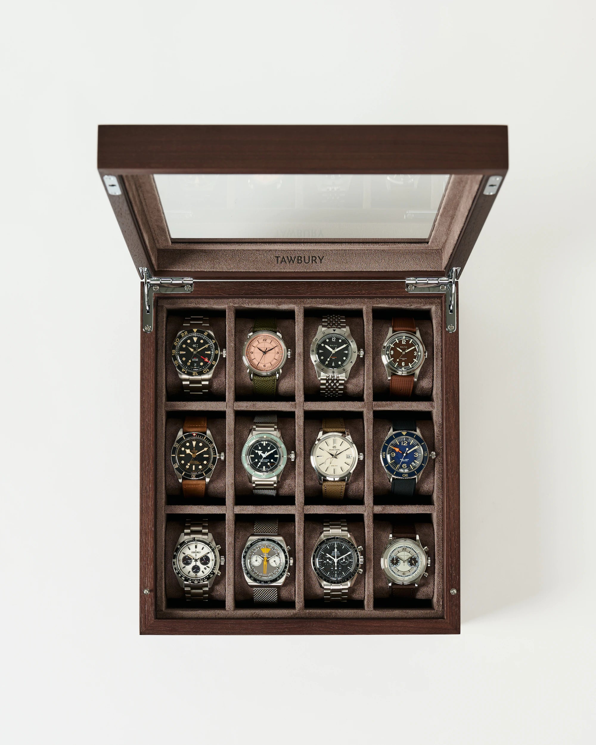 The TAWBURY Grove 12 Slot Wooden Watch Box in dark walnut wood features a glass lid and three rows of four slots, making it perfect for organizing and elegantly displaying your watch collection.