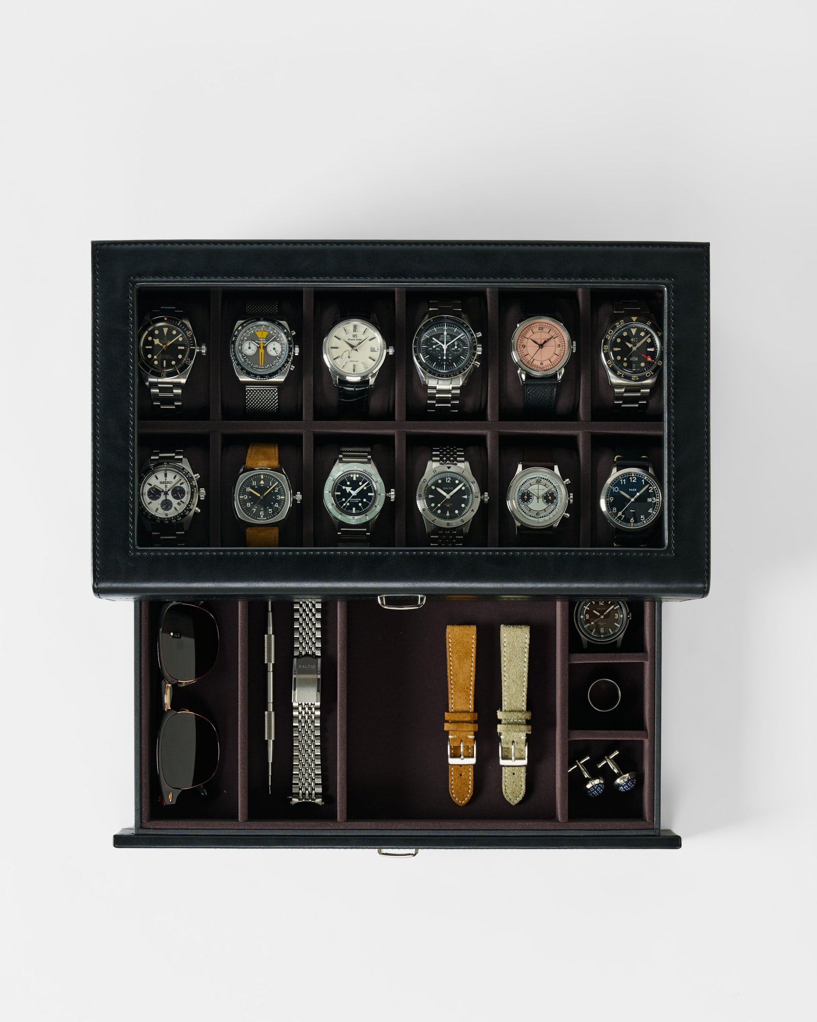 The TAWBURY Bayswater 12 Slot Watch Box with Storage in Black/Charcoal neatly displays twelve watches above and stores accessories like sunglasses, straps, and cufflinks in a bottom compartment.
