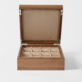 The TAWBURY Grove 12 Slot Wooden Watch Box in Classic Walnut features a closed lid and plush beige lining—an elegant storage solution for your watch collection.