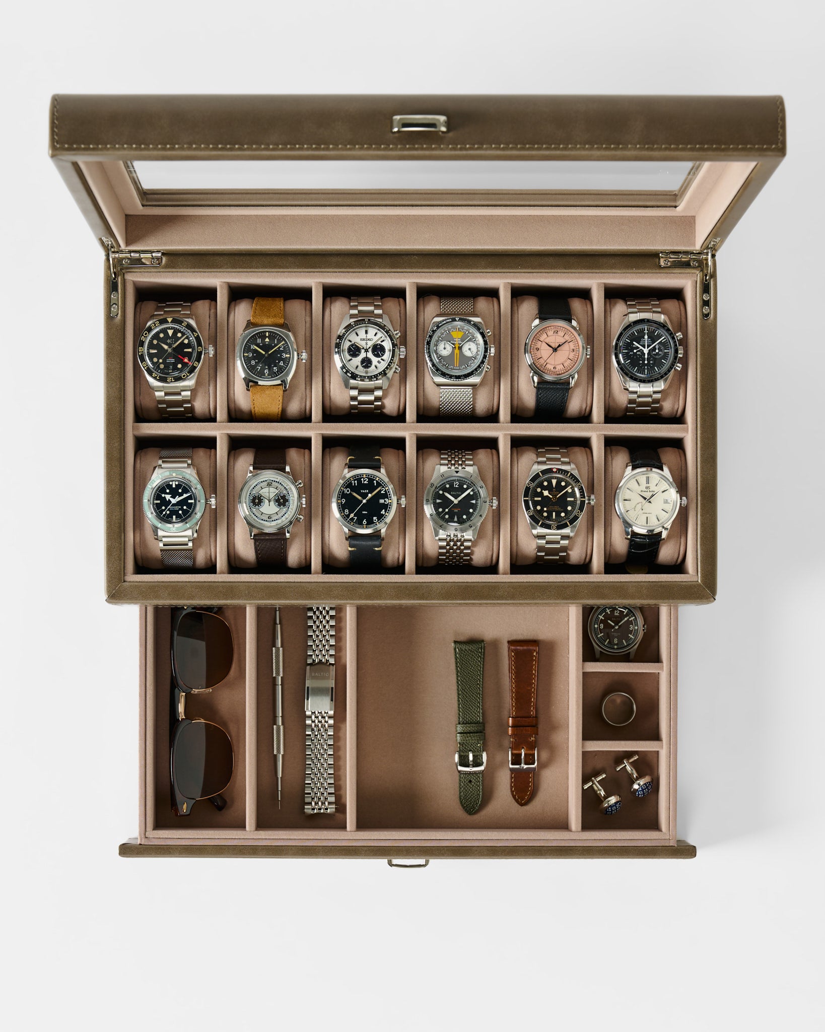 The TAWBURY Bayswater 12 Slot Watch Box with Storage in Taupe keeps your wristwatches, sunglasses, watch bands, tools, and cufflinks elegantly arranged in dedicated compartments for stylish watch organization.