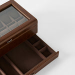 The TAWBURY Bayswater 12 Slot Watch Box with Storage in brown features a glass lid, divided upper compartment for watches, and a pull-out drawer with sections for accessories.