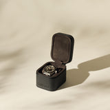The TAWBURY Fraser 1 Watch Case in black is shown open on a neutral background, featuring soft lighting and subtle shadows.