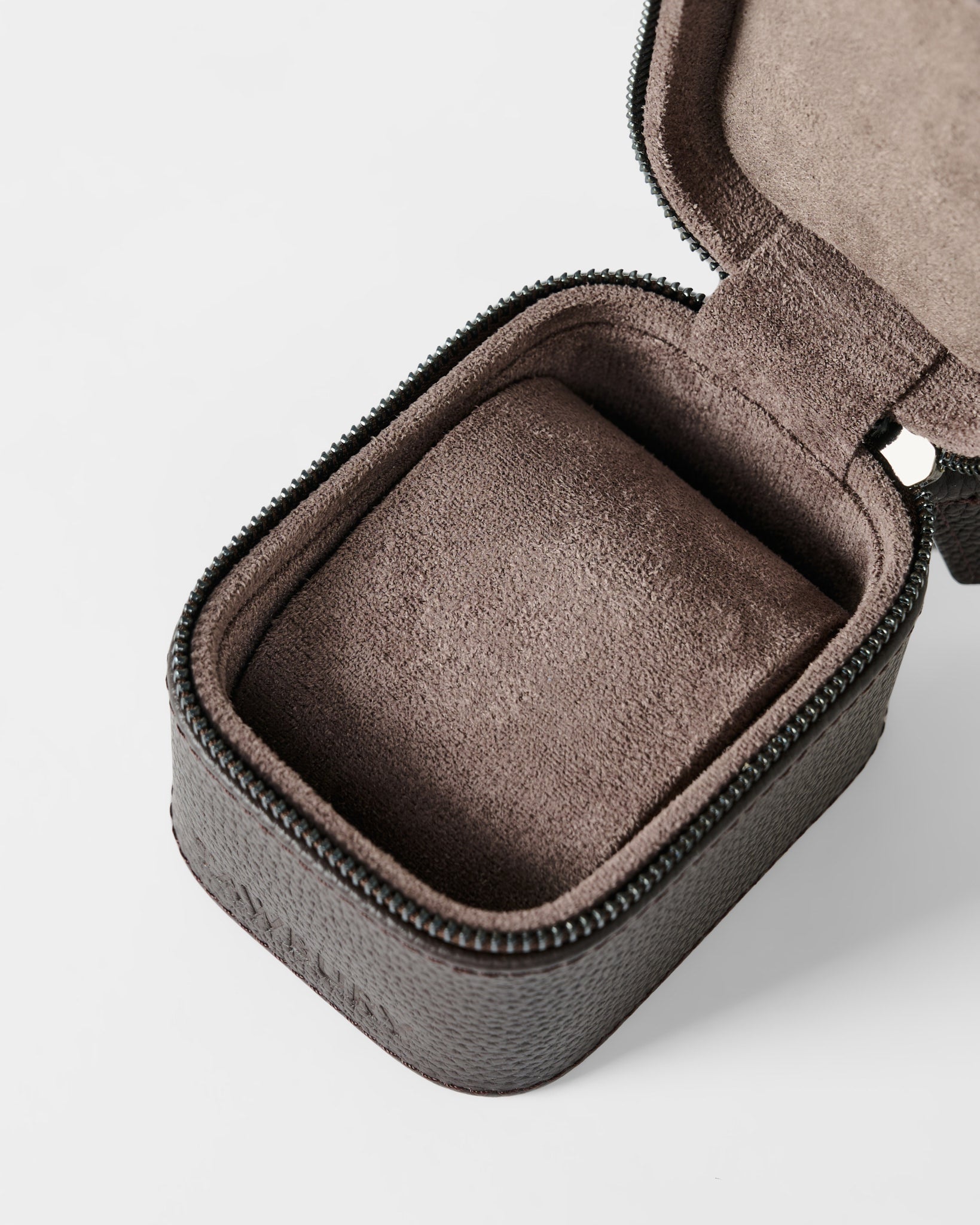 The TAWBURY Fraser 1 Watch Case - Brown features a textured leather exterior, zippered closure, and a soft cushioned insert—partially open to show the interior—making it ideal for elegant watch storage while traveling.
