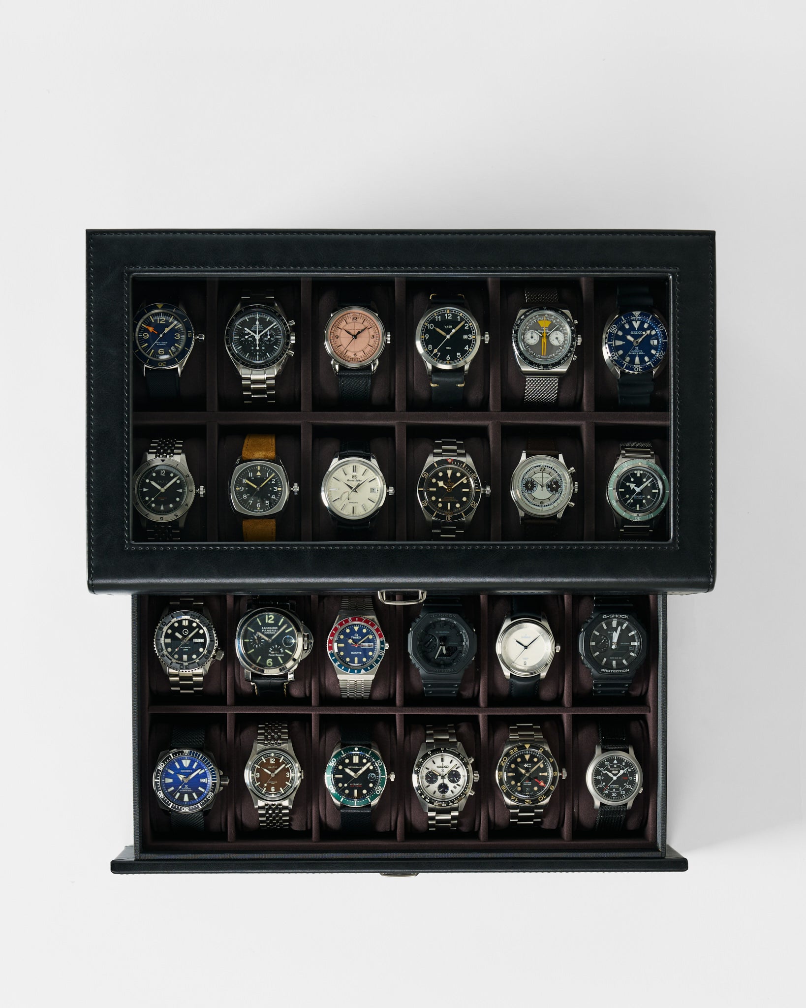 The TAWBURY Bayswater 24 Slot Watch Box with Drawer in Black/Charcoal neatly displays and organizes up to 24 wristwatches, keeping your collection secure and stylishly arranged.