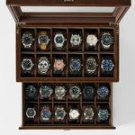 The TAWBURY Bayswater 24 Slot Watch Box with Drawer in brown features a glass lid and is ideal for storing up to 24 watches, elegantly displayed in rows on a white background.