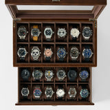 The TAWBURY Bayswater 24 Slot Watch Box with Drawer in brown features a glass lid and is ideal for storing up to 24 watches, elegantly displayed in rows on a white background.