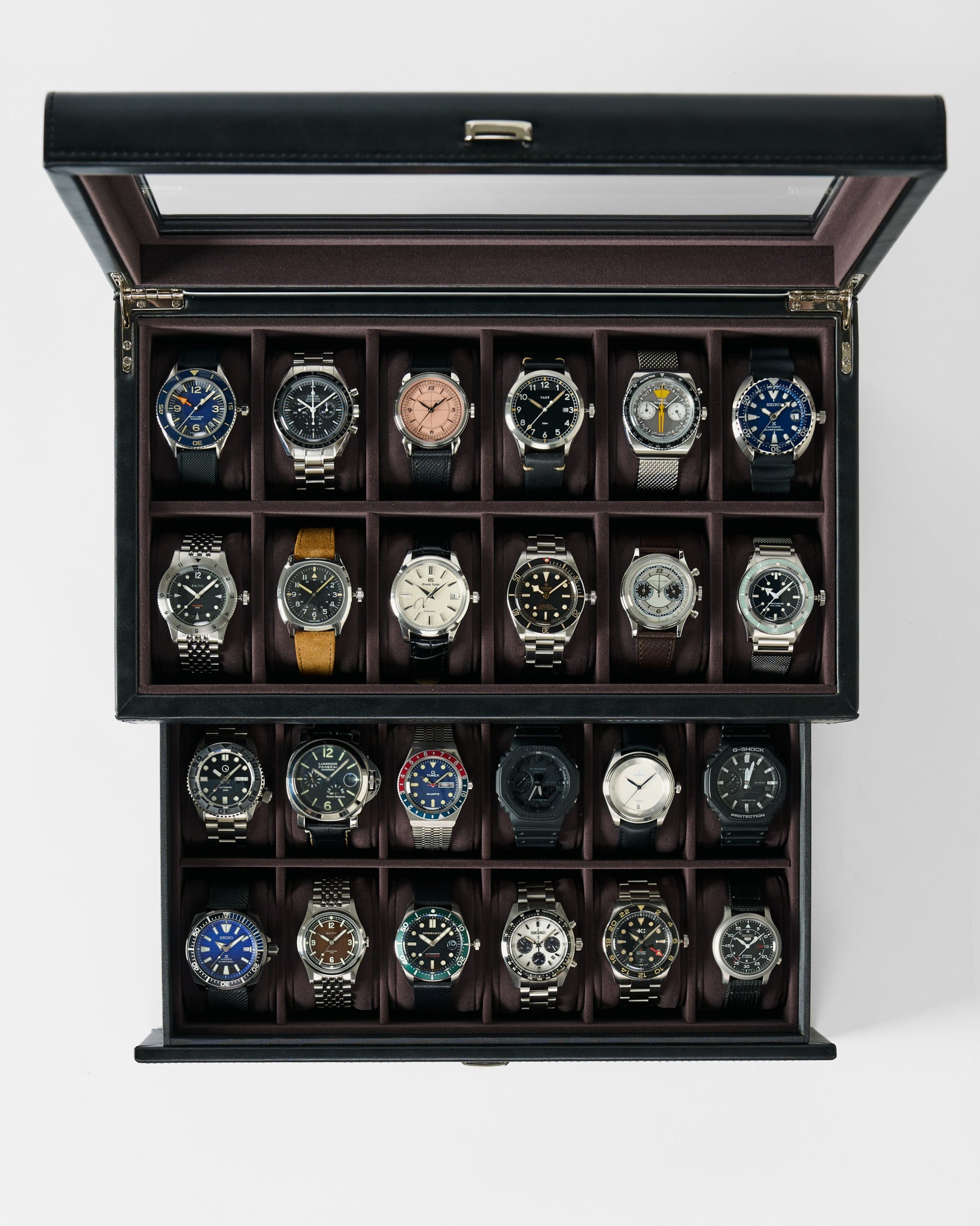 The TAWBURY Bayswater 24 Slot Watch Box with Drawer in Black/Charcoal holds up to 24 wristwatches, neatly organized in slots, offering stylish storage for various watch bands and face designs.
