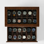 The TAWBURY Bayswater 24 Slot Watch Box with Drawer in brown is shown from above, featuring twenty wristwatches neatly stored in individual compartments against a white background.
