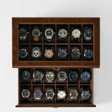 The TAWBURY Bayswater 24 Slot Watch Box with Drawer in brown is shown from above, featuring twenty wristwatches neatly stored in individual compartments against a white background.