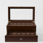 The TAWBURY Bayswater 24 Slot Watch Box with Drawer in Chestnut Brown features an open glass lid, pull-out drawer, and watch pillows for organized storage.
