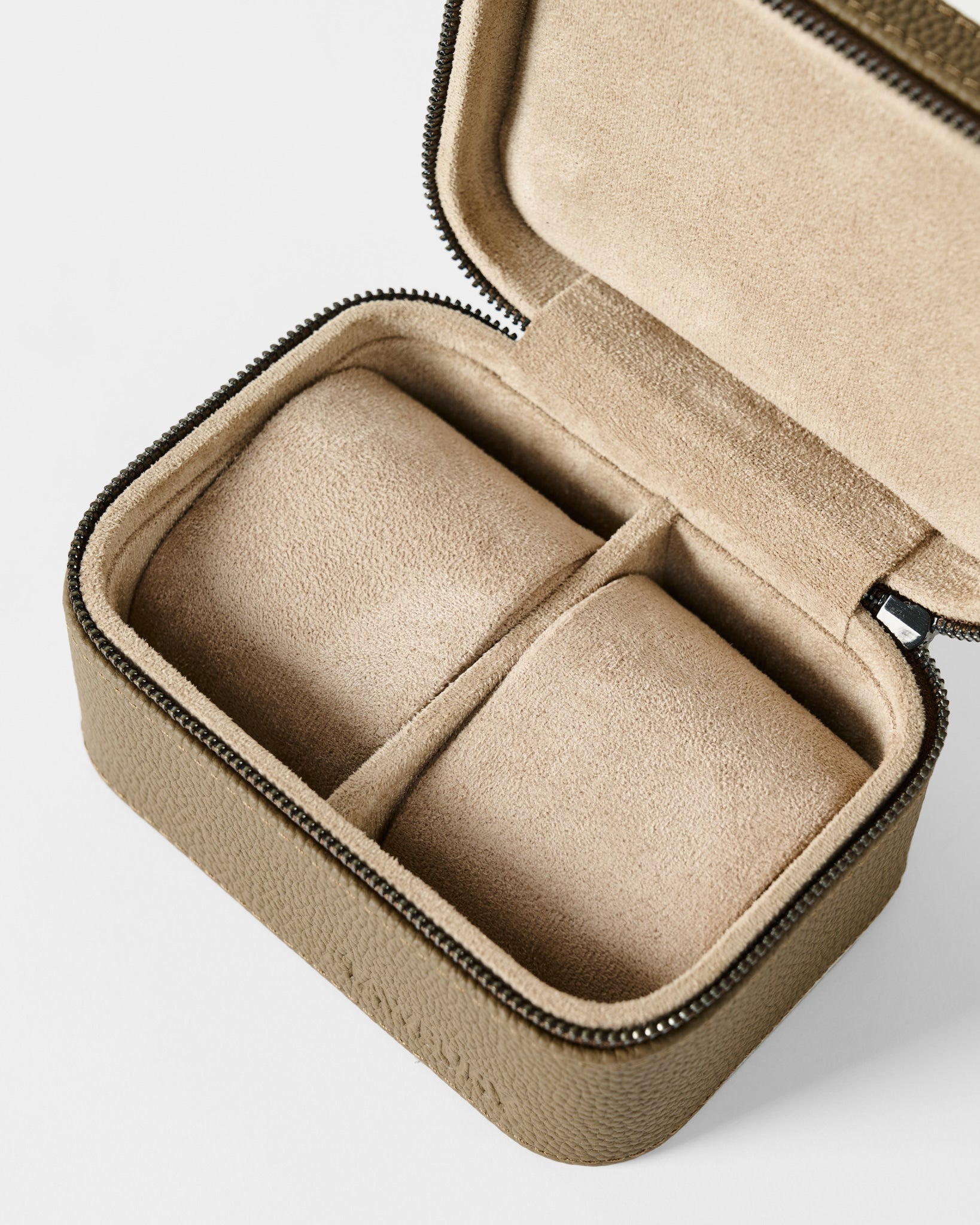 The TAWBURY Fraser 2 Watch Case - Taupe is a compact, rectangular zippered case with a soft beige interior and two compartments, perfect for storing watches or jewelry while traveling.