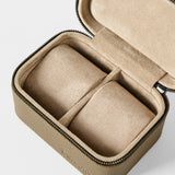 The TAWBURY Fraser 2 Watch Case - Taupe is a compact, rectangular zippered case with a soft beige interior and two compartments, perfect for storing watches or jewelry while traveling.