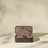 The TAWBURY Fraser 3 Watch Case in brown leather sits open, displaying a wristwatch inside—ideal for travel storage—against a neutral backdrop with gentle shadows.