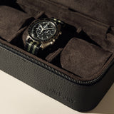 The TAWBURY Fraser 3 Watch Case - Black is a sleek black textured leather case with a zipper and suede interior, ideal for stylishly storing your watches on the go.