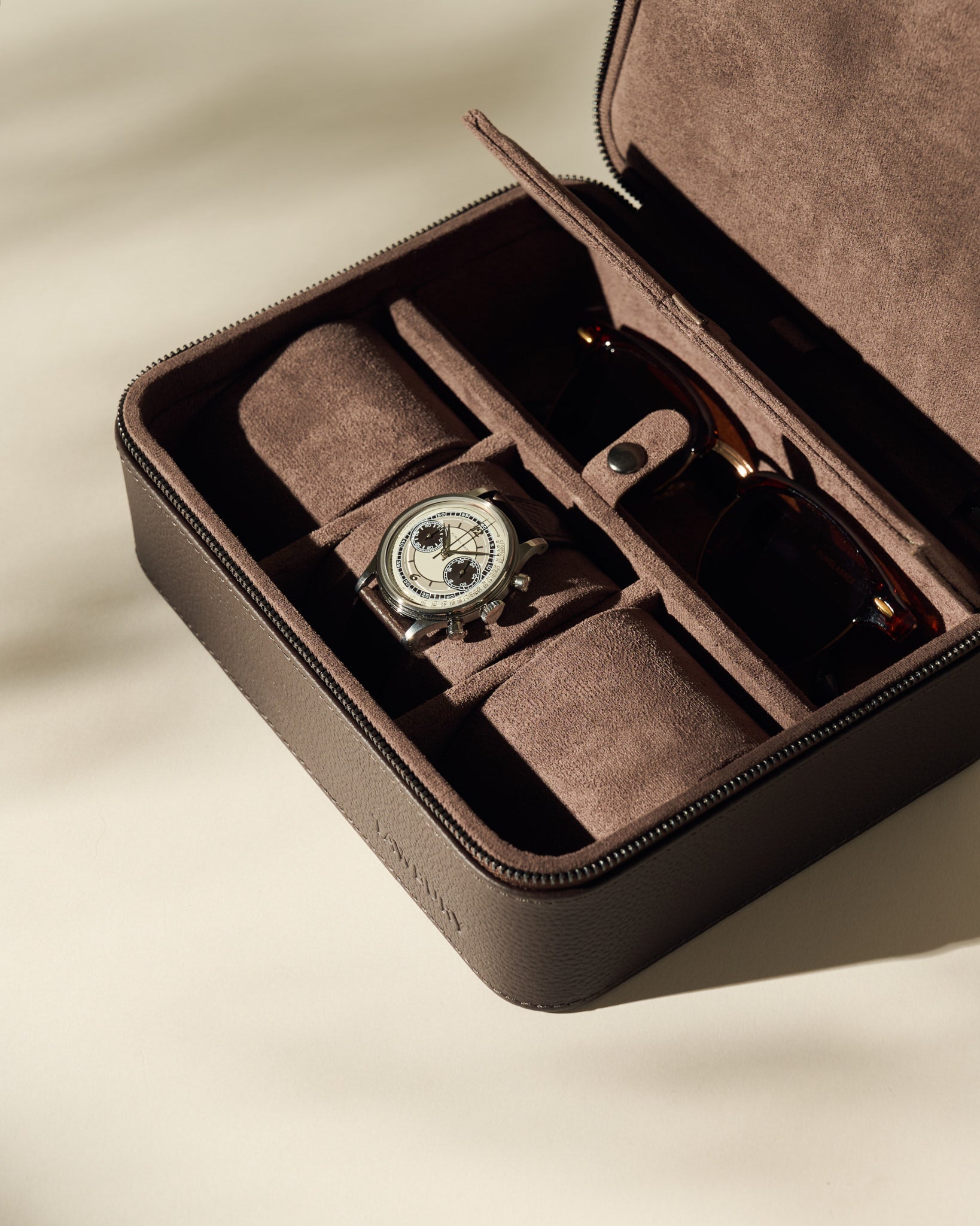 The TAWBURY Fraser 3 Watch Case with Storage - Brown features a suede-lined interior and compartments for your wristwatch and sunglasses. Open on a light surface, it's ideal for organized watch storage on the go.