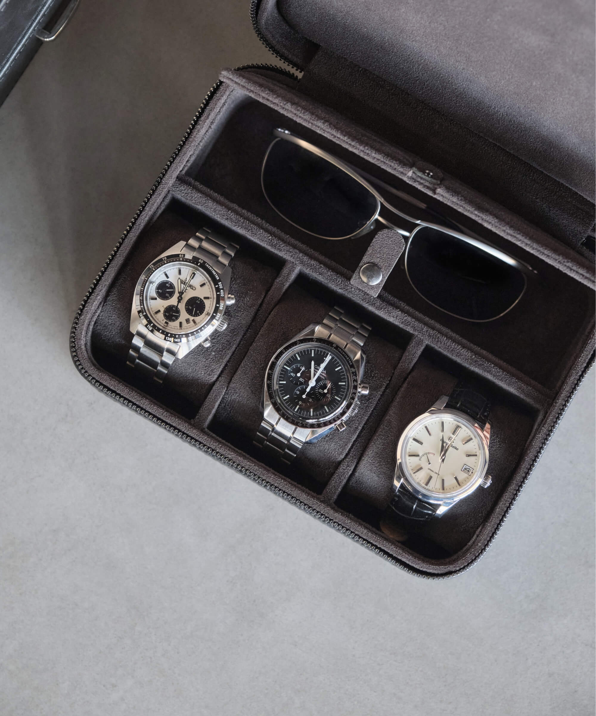 A TAWBURY Fraser 3 Watch Travel Case with Storage - Black that provides storage for four watches and sunglasses.