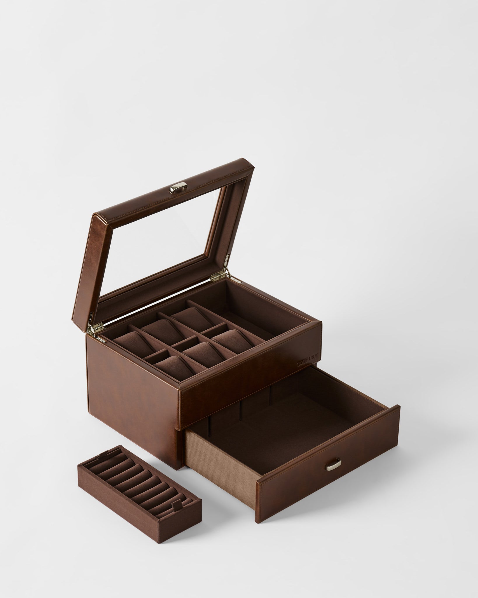 The TAWBURY Bayswater 6 Watch Jewelry Box in brown features an open glass lid, multiple compartments, a pull-out drawer, and a removable ring holder tray, all displayed against a plain background.