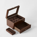 The TAWBURY Bayswater 6 Watch Jewelry Box in Chestnut Brown features an open lid, multiple compartments, a pull-out drawer, and a removable ring section for elegant watch storage against a plain background.