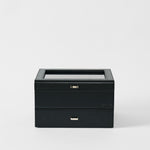 The TAWBURY Bayswater 6 Watch Jewelry Box in Midnight Black features a glass top and two closed drawers, set against a plain white background.