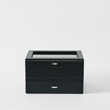 The TAWBURY Bayswater 6 Watch Jewelry Box in Midnight Black features a glass top and two closed drawers, set against a plain white background.