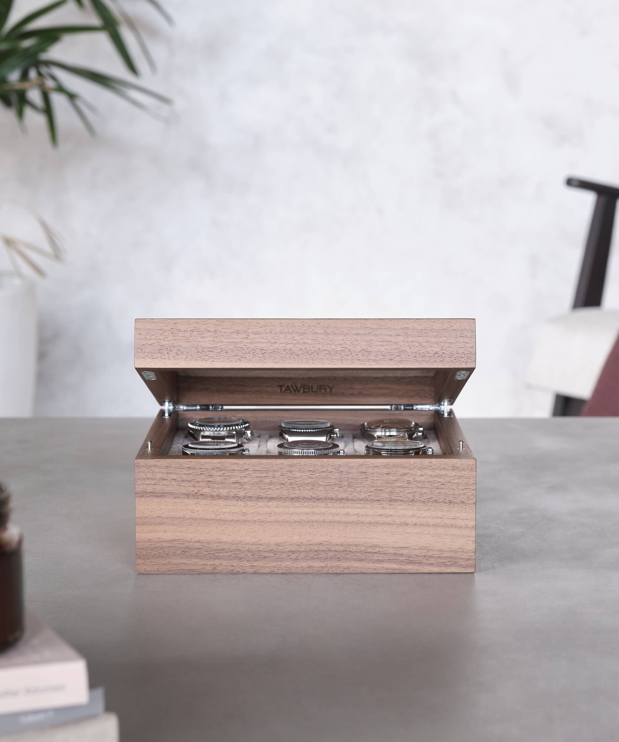A TAWBURY Grove 6 Slot Watch Box with Solid Lid - Walnut with timepieces in a wooden box.